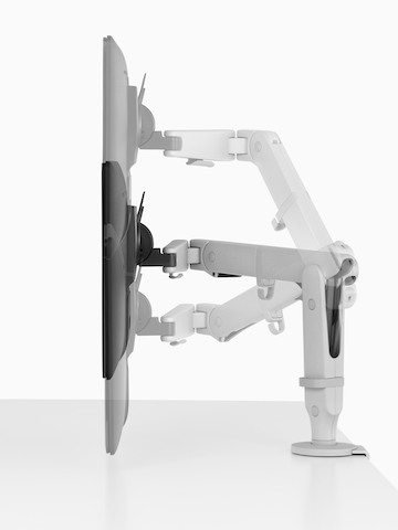 Profile view of an adjustable Ollin Monitor Arm positioning a monitor at three different heights.