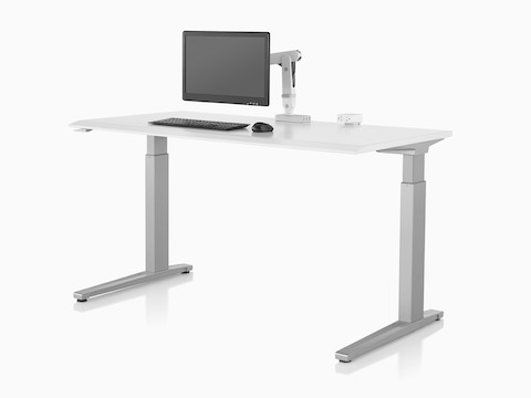 An Ollin Monitor Arm elevates a monitor off the surface of a sit-to-stand table.