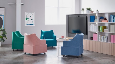 Four Plex club chairs in vibrant shades of blue, green, purple, and salmon in an informal meeting space.