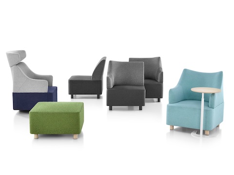 A collection of Plex seating elements, including gray modular components, blue club chairs, and a green ottoman.