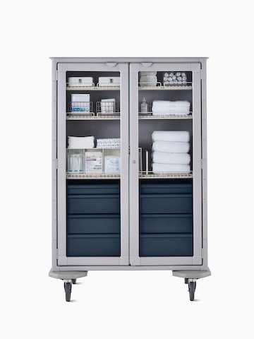 Mobile double-wide supply cart with light gray body, dark blue drawers, wire shelves, and locking glass doors.