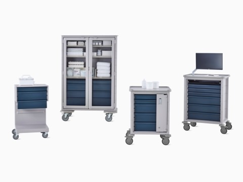 Group of Procedure and Supply Carts including L Cart, double-wide cart, supply cart, and technology cart in light gray body with dark gray drawers.