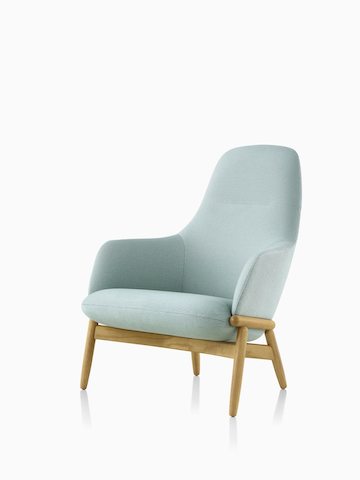 A high-back Reframe Lounge Chair in Saille Celadon, viewed from an angle. Select to go to the Reframe Lounge Seating product page.