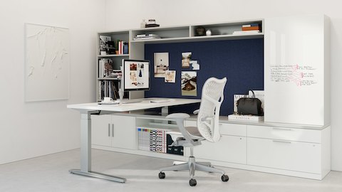 Canvas Private Office with white lower storage, gray overheard storage, dark blue fabric panel, writable panel storage, and a Renew Sit-to-Stand Table.