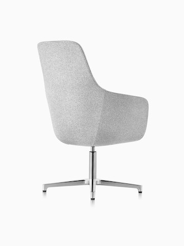 Three-quarter rear view of a high-back Saiba lounge chair in light gray fabric with a polished four-star base and glides.