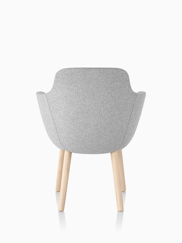 Rear view of a light gray Saiba Side Chair with an upholstered bucket seat and wood legs.