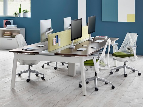 White Sayl office chairs with green upholstered seats in a benching work setting.
