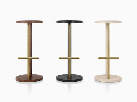 Family of Spot Stools in white ash, walnut, and ebony with brass finish, viewed from the front.