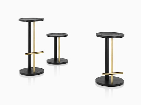 Family of Spot Stools in ebony with brass finish, viewed at an angle.