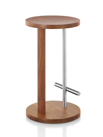 Oblique view of a medium-height Spot Stool with a medium wood finish and silver crossbar footrest.