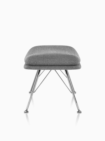 Side view of Striad Ottoman in gray upholstery with wire base. 