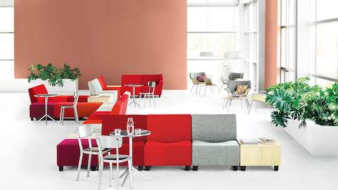 Gathering space featuring Swoop Lounge Furniture, both modular seating components and lounge chairs.