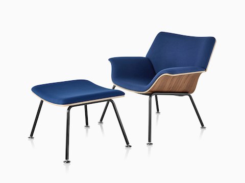 Swoop Plywood Lounge Chair and Ottoman with dark royal blue upholstery viewed from a 45-degree angle.