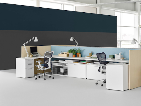 Tu storage components support the surfaces in a U-shaped open work area. 