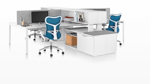 A Tu credenza with a cushion top provides guest seating for two adjacent workstations.