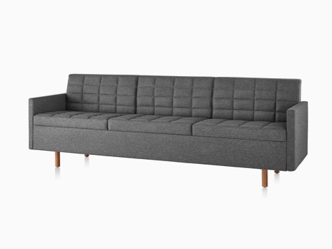Dark gray Tuxedo Classic sofa with wood legs, viewed from the front on an angle.
