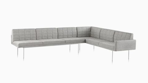 A Tuxedo Component Sofa corner unit with a metal base and quilted upholstery.