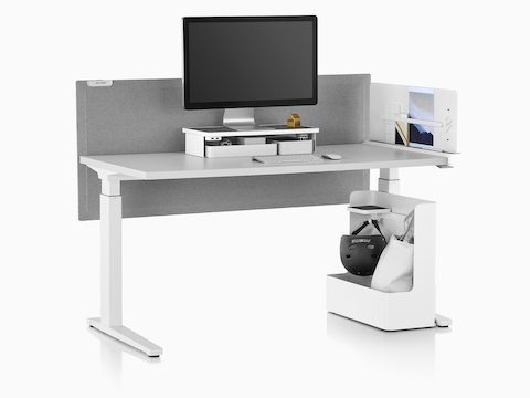 A rectangular sit-to-stand table equipped with Ubi Work Tools, including a monitor platform shelf and mobile bag catch.