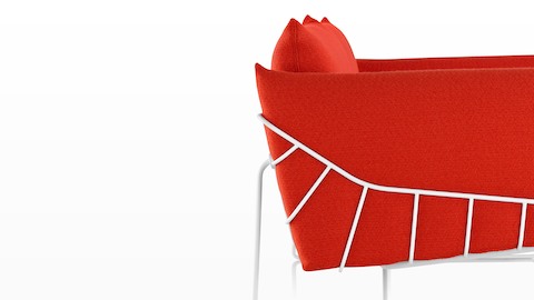 Profile view of a red Wireframe lounge chair.