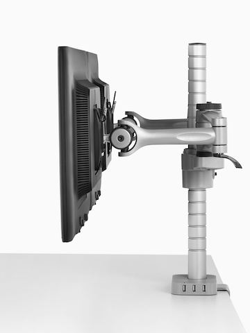 Profile view of two side-by-side monitors attached to a single Wishbone Monitor Arm post.
