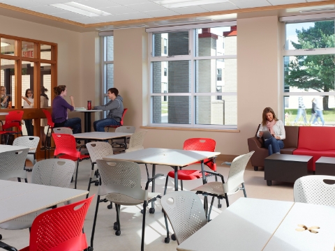Students sit amidst Cper chairs and Swoop lounge seating inside of an open common area.