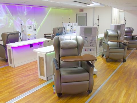 A row of Nemschoff Serenity Chairs sit amidst dialysis machines.