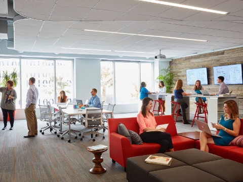 People work and converse in an open office setting with Setu chairs and lounge seating. 