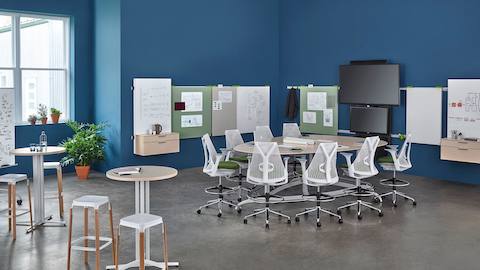 A large conference room and workspace with Sayl chairs and additional stool seating. 