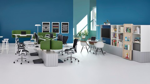 An open workspace setup with private workstations, standings desks, and communal seating options. 