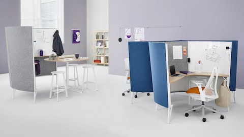 A Prospect collaborative space near two Prospect solo spaces with blue acoustic fabric and white Sayl Chairs with orange upholstered seats.