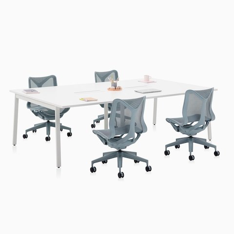 A Layout Studio meeting table with power access and four low-back Cosm Chairs in gray.