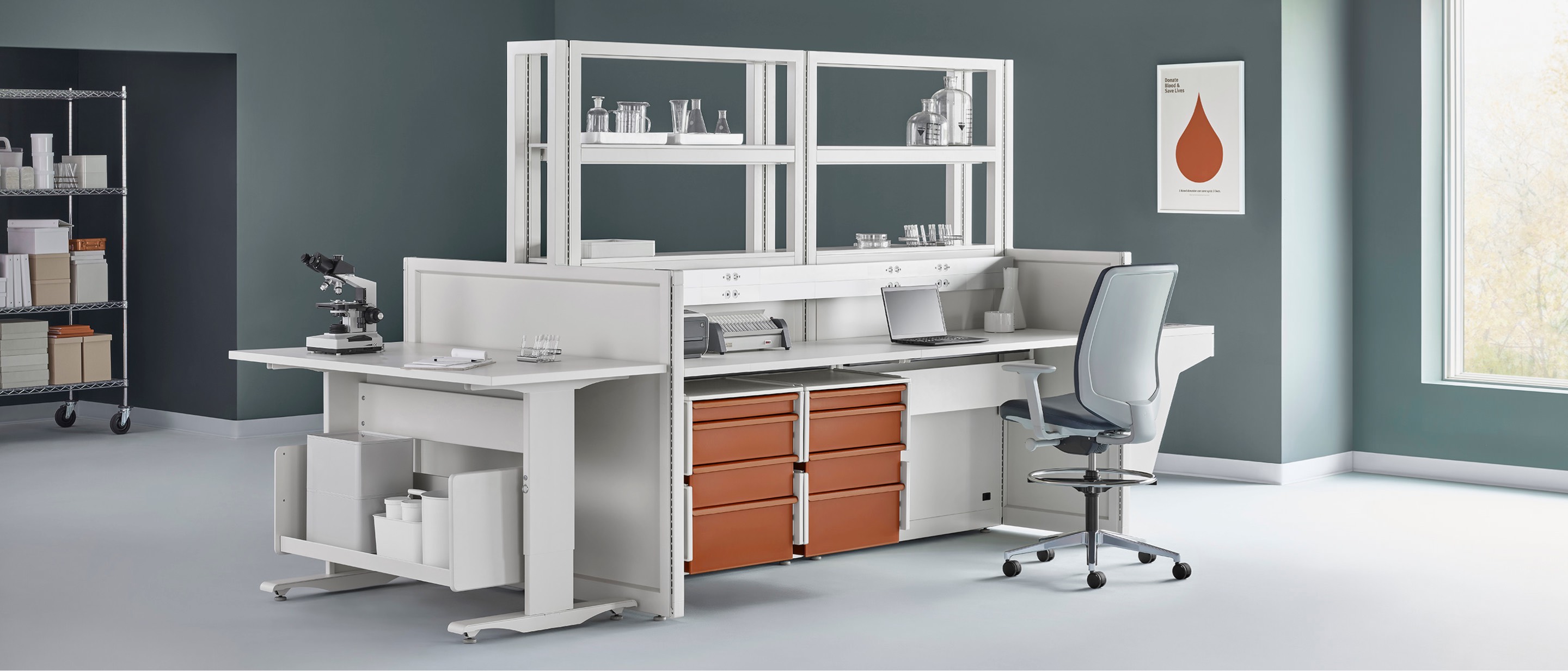 A lab setting with a Co/Struc System workstation and shelving in the center with a Verus work stool.