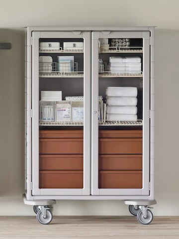 A medical clean supply room featuring a double-wide Procedure and Supply Cart with lockable glass doors.