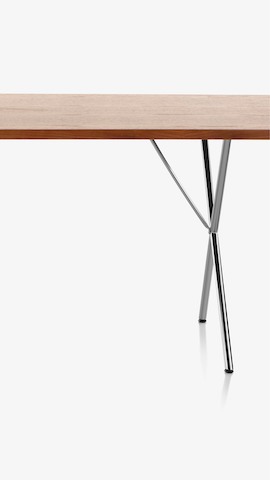 Partial view of a Nelson X-Leg Table. Select to see dining tables available from the Herman Miller Store. 