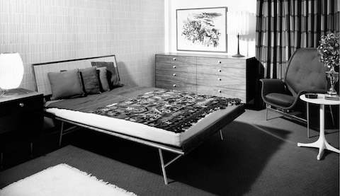 A black-and-white image of a mid-century modern bedroom.