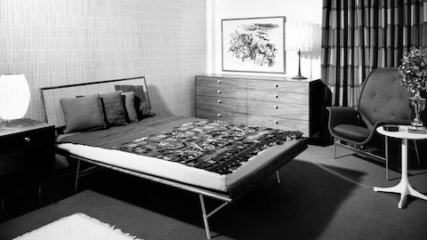 A black-and-white image of a mid-century modern bedroom. Select to go to an article about designer George Nelson's writing.