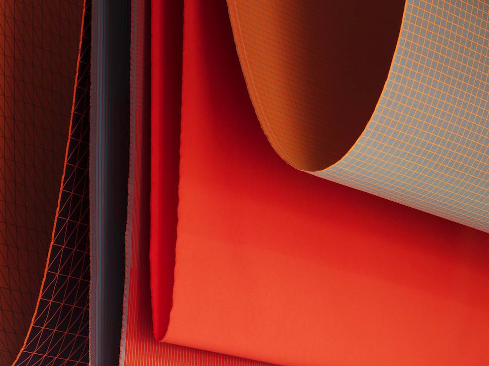 Clove view of textiles in various shades of red and orange.