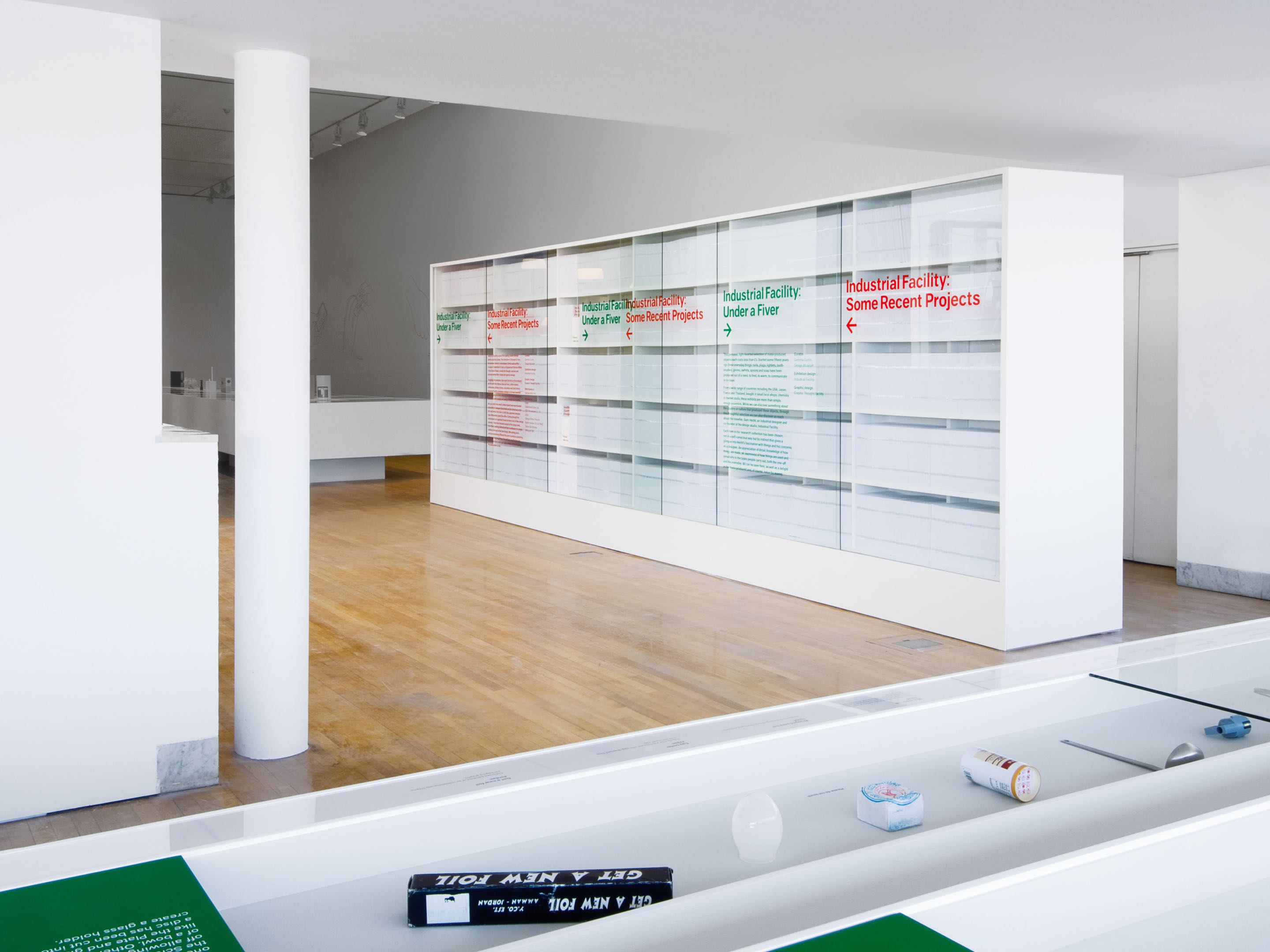 A white bookcase wall used as a wayfinding element at the Design Museum in London.