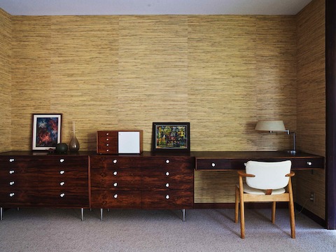 Vintage rosewood Thin Edge cabinets and a custom floating desk line one wall of the master bedroom. The Nelson Miniature Chest was the first vintage Herman Miller piece Corner collected. 