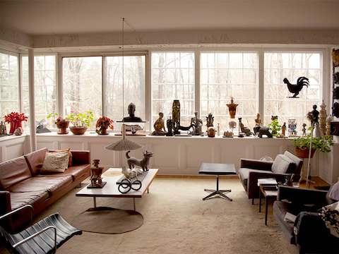 Sculptures created by designer Irving Harper occupy a window seat in the living room of his home.