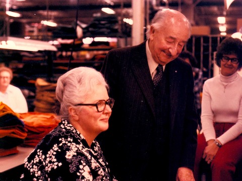 A color photo of Herman Miller founder D.J. De Pree laughing with employees.