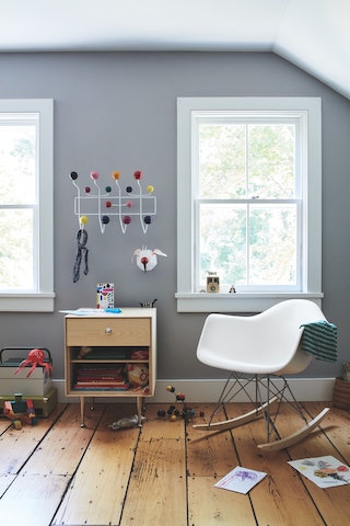 Eames Molded Plastic Rocker, an Eames Hang It All, and a Nelson Thin Edge Storage unit complete this play room.