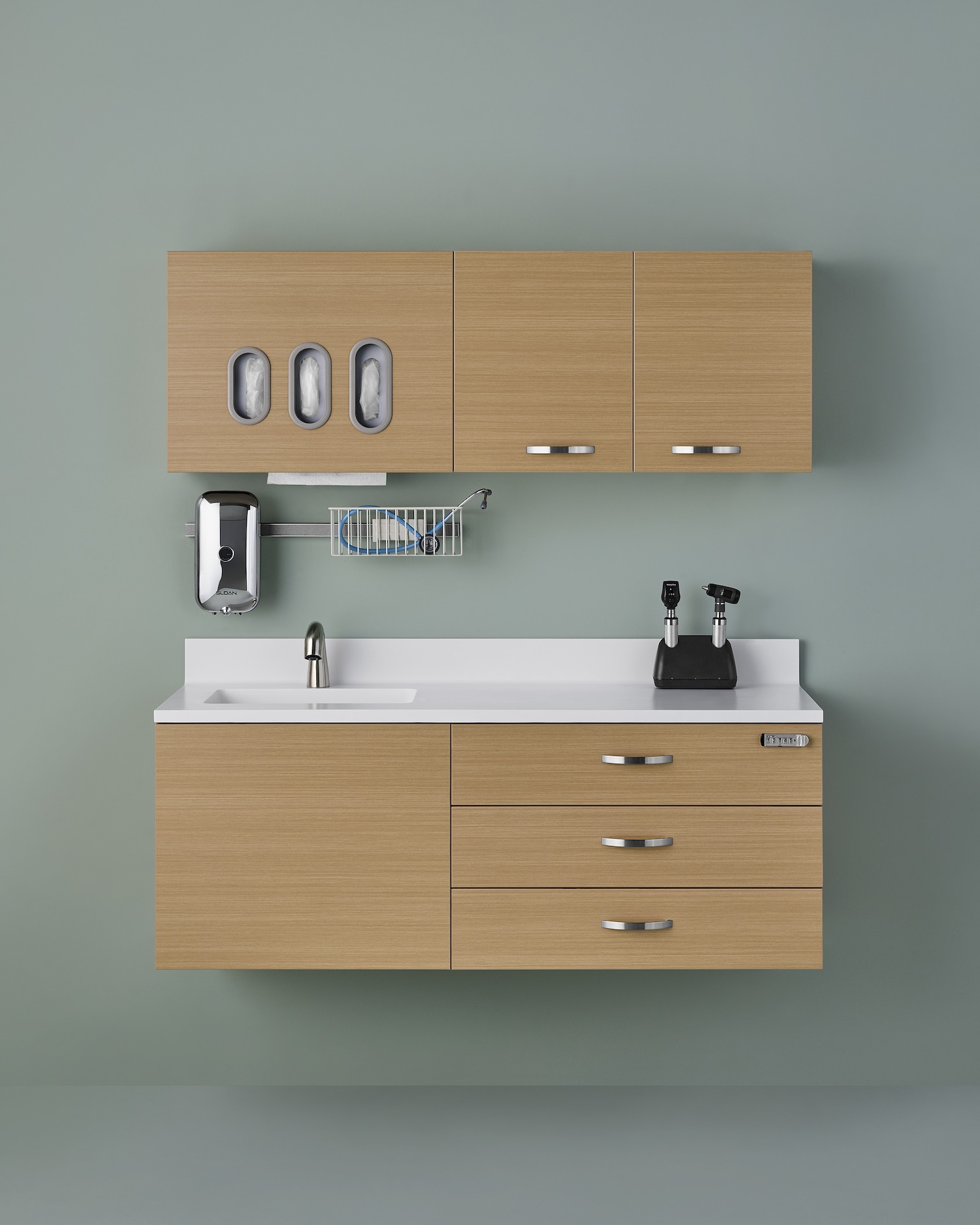 Mora System casework in a medium-tone wood finish hung on a green wall with lower and upper storage.