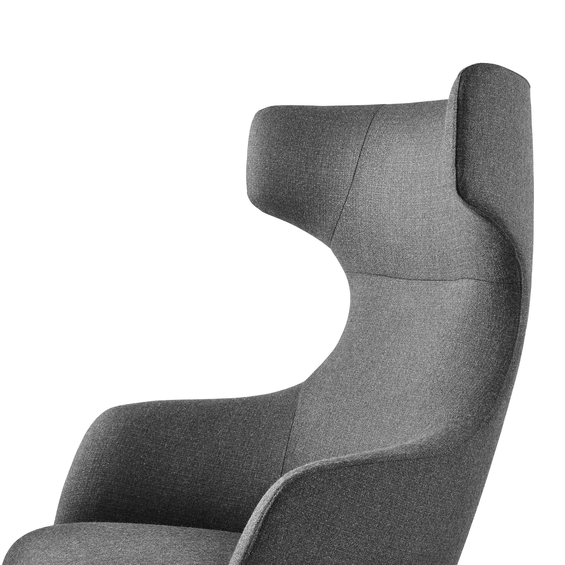 A close-up of a wing-back Reframe Lounge Chair in Milaner Charcoal, viewed in a thee-quarter perspective.