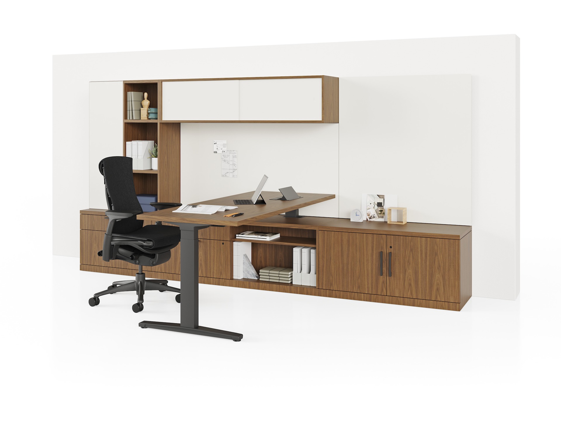 Dark wood Canvas Private Office with height adjustable table, storage, and black Embody Chair. 