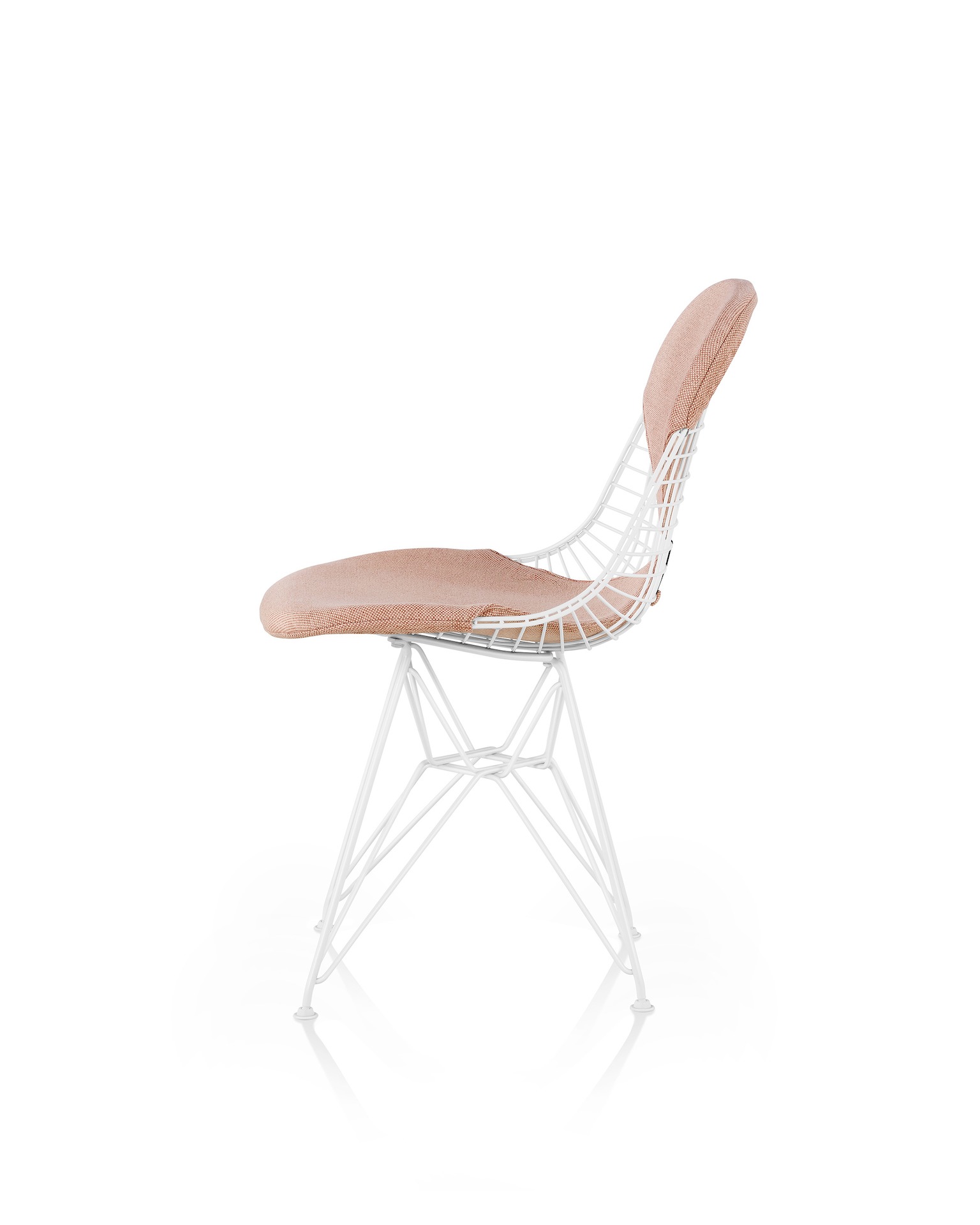 A white Eames Chair with a light pink bikini seat and back and a white wire base. Viewed from the side.