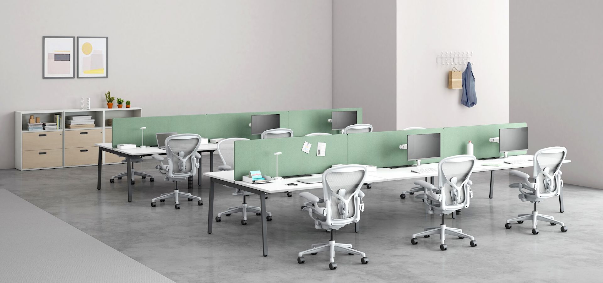 Two back-to-back, six-person Layout benches, each with a light grey Aeron Chair.