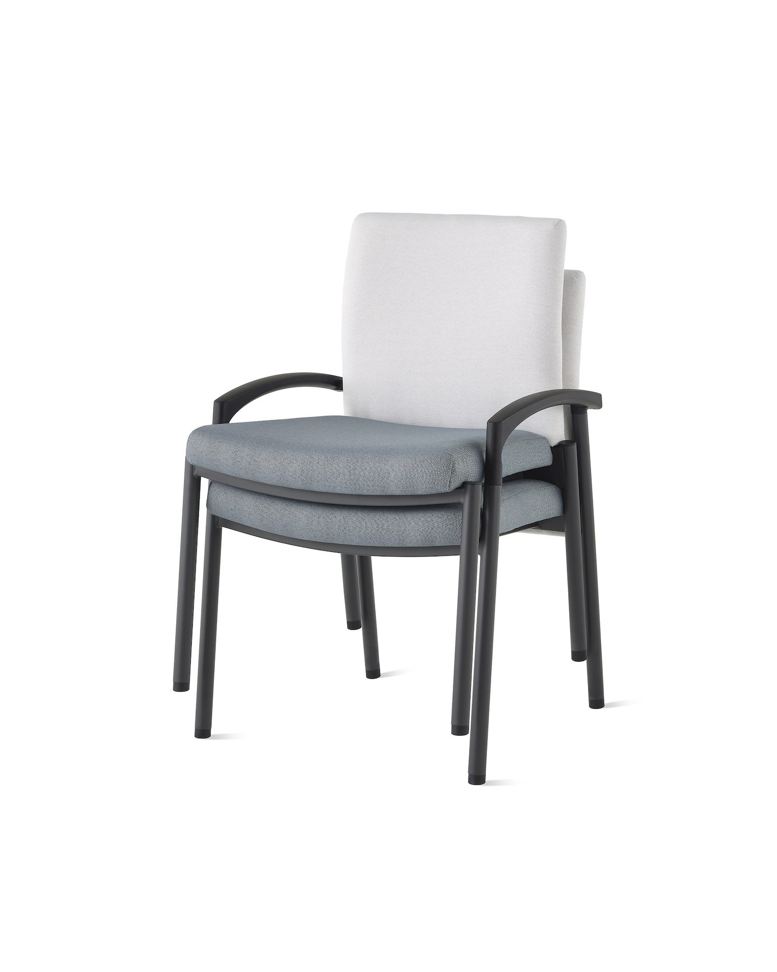 Three-quarter, front view of two Valor stacking chairs without arms stacked, with a white back upholstery and blue seat upholstery and black frame on white sweep.