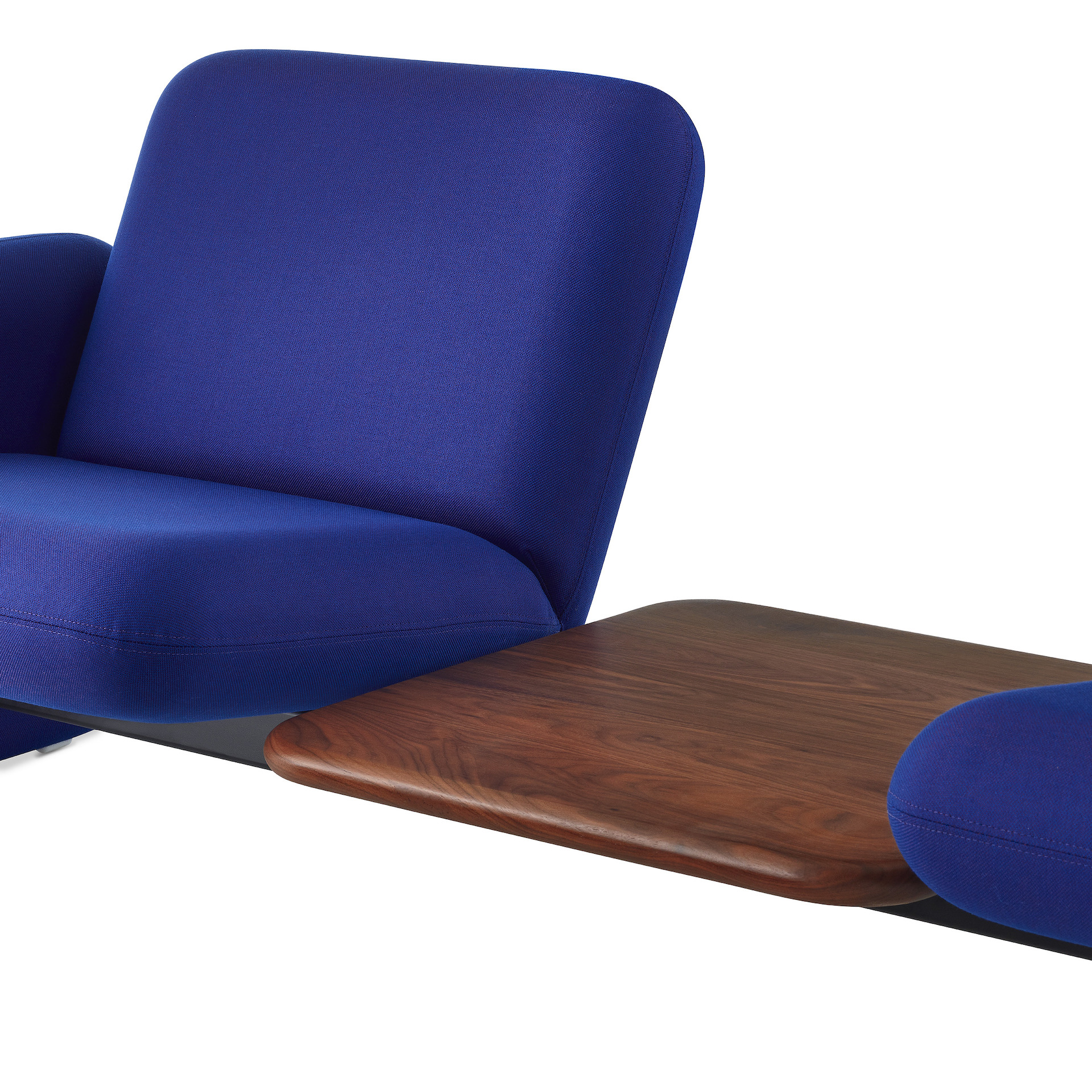 Close of angle view of a brown table between 2 middle seats of a Wilkes Modular Sofa Group Sofa in blue.