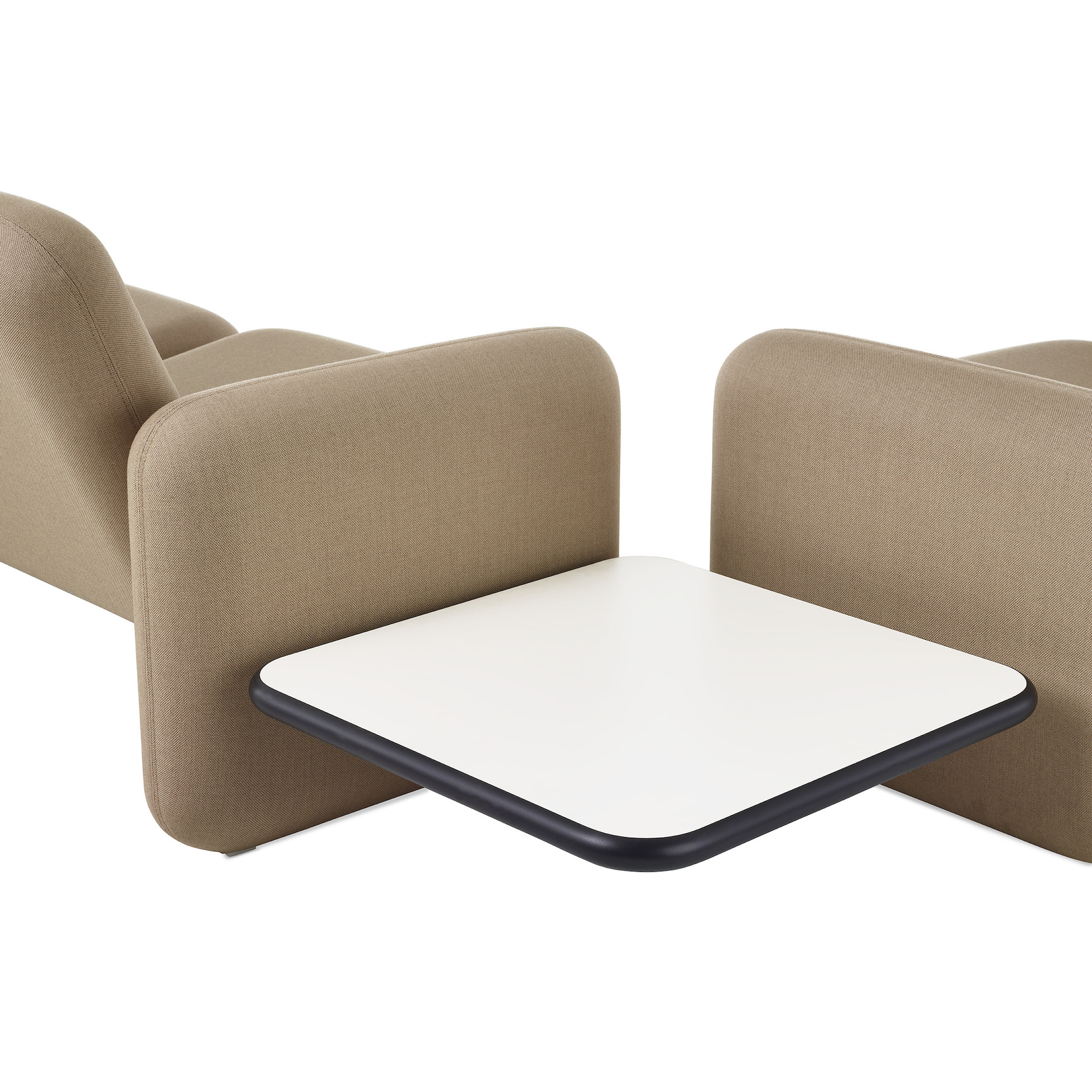 Close up view of a Wilkes Modular Sofa Group Sofa  with a white table a right angle to another  Wilkes Modular Sofa Group sofa, both in khaki.